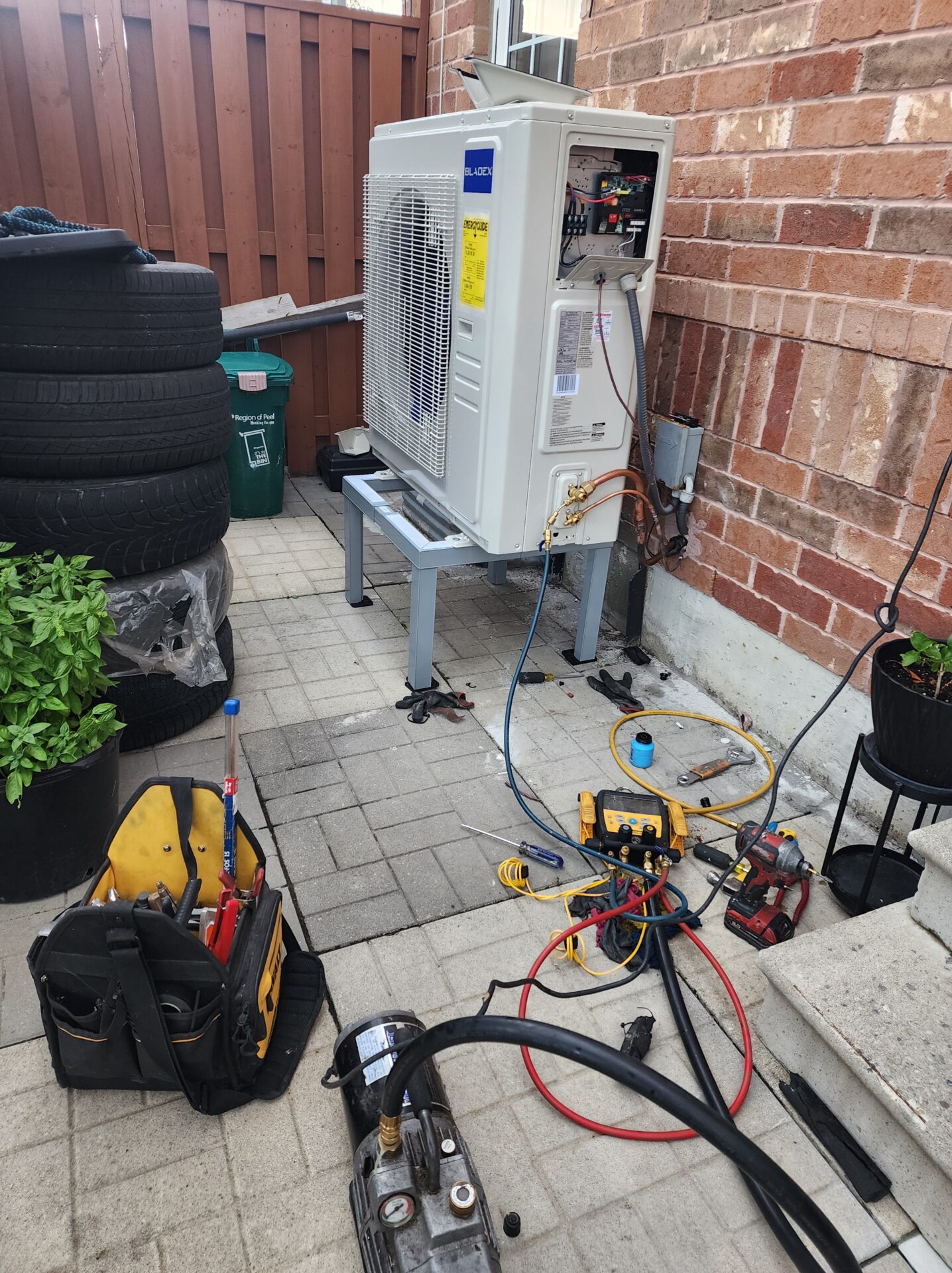 Bladex heat pump installation with a vacuum pump and digital gauges attached for system commissioning by Hawana HVAC Solutions