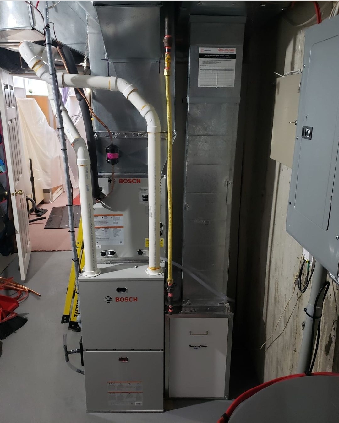 A complete Bosch indoor HVAC system including a gas furnace and cased coil installed in a basement, equipped with a GeneralAire whole-home humidifier.