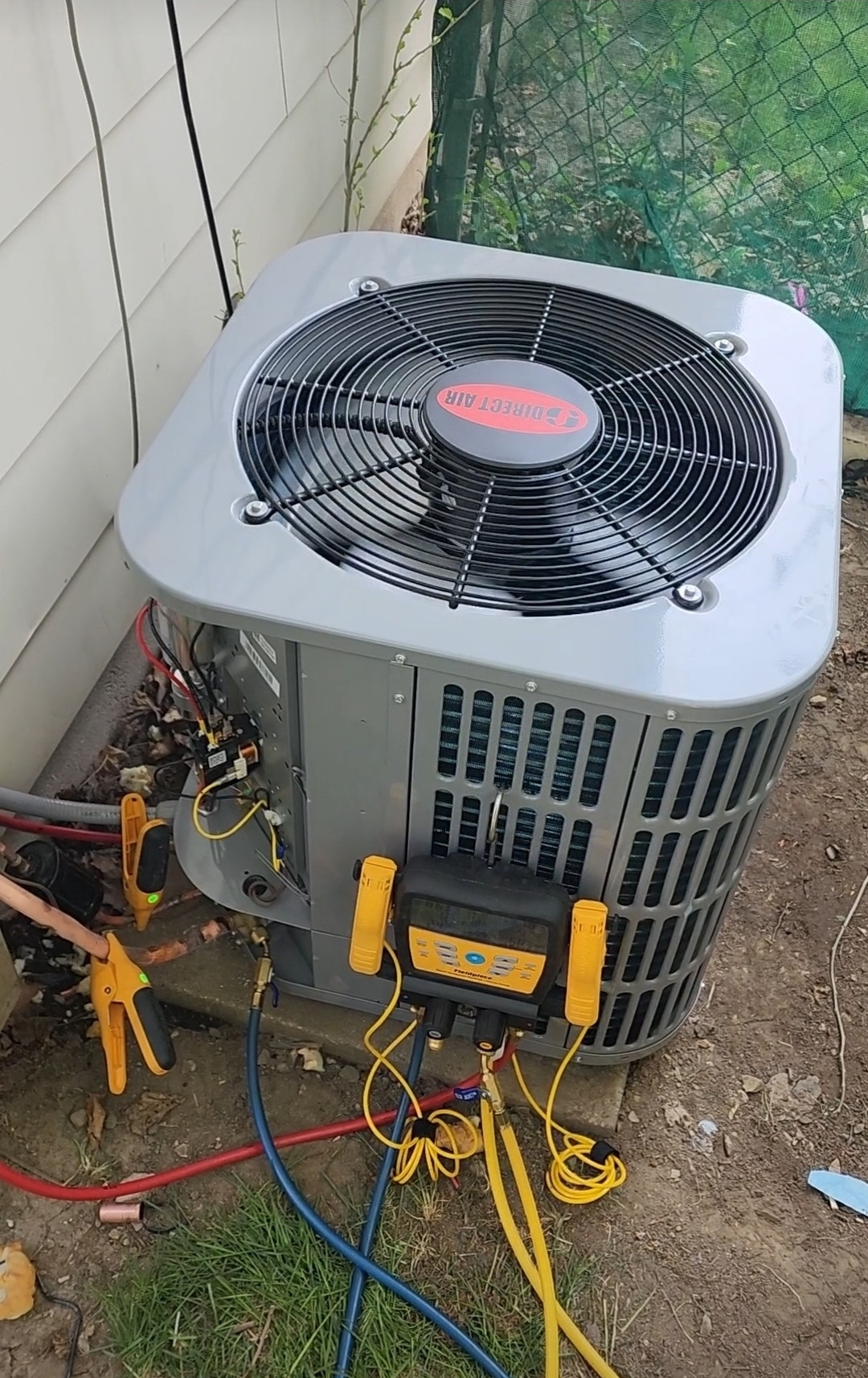 Fieldpiece digital manifold gauges connected to a Direct Air air conditioner for pressure testing.