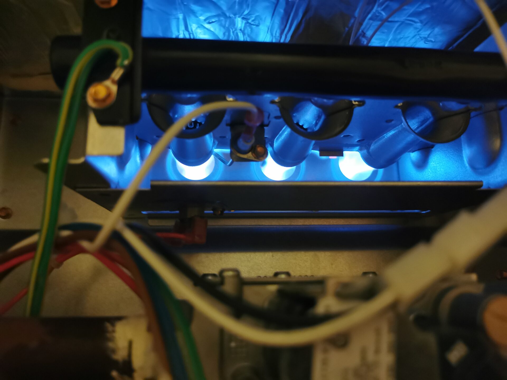 High-resolution view of crisp, clean blue flames firing steadily inside a residential gas furnace burner during combustion analysis London Ontario