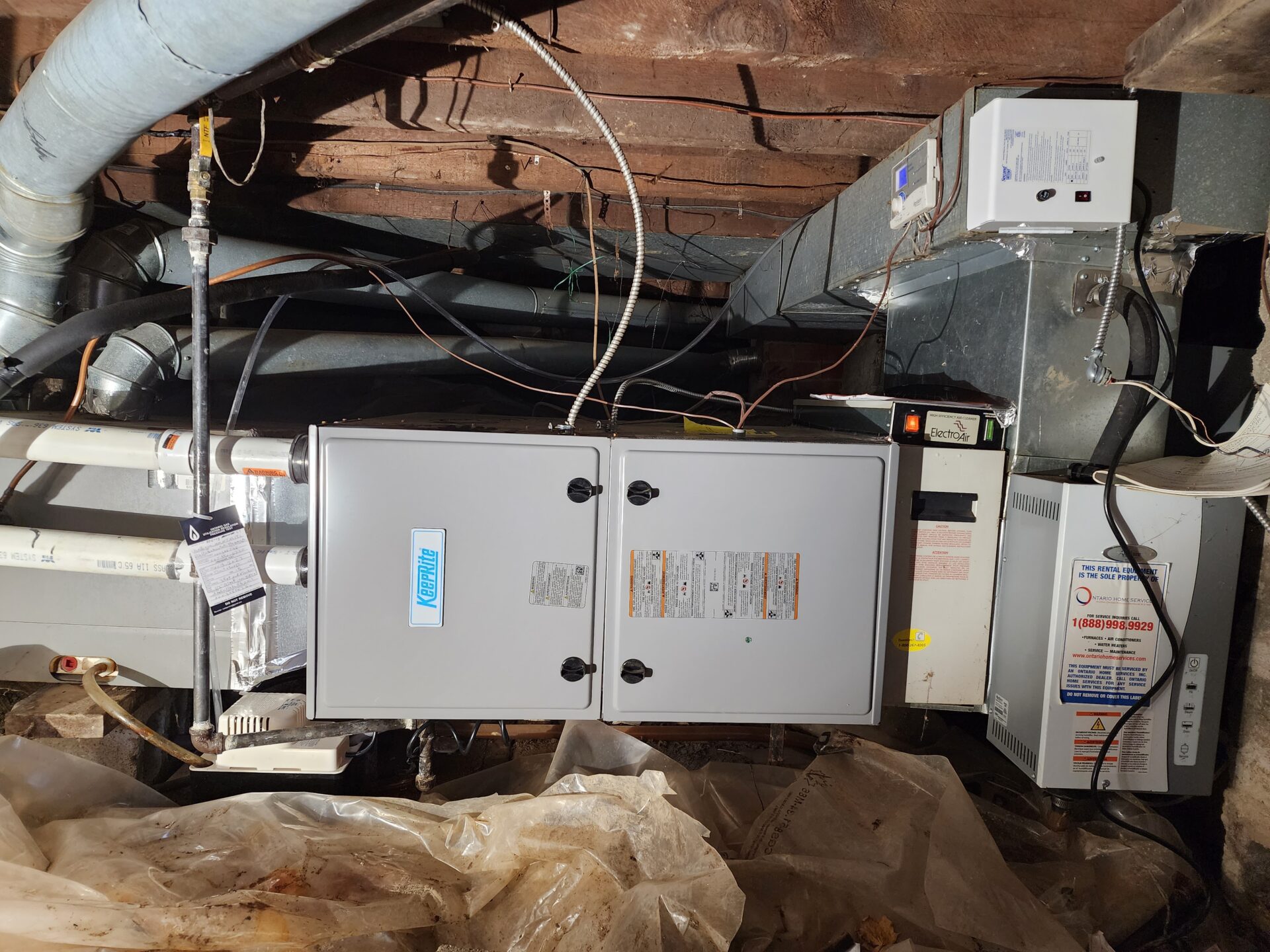 A KeepRite gas furnace paired with an Electro-Air HEPA filtration system installed horizentally in crawl space .