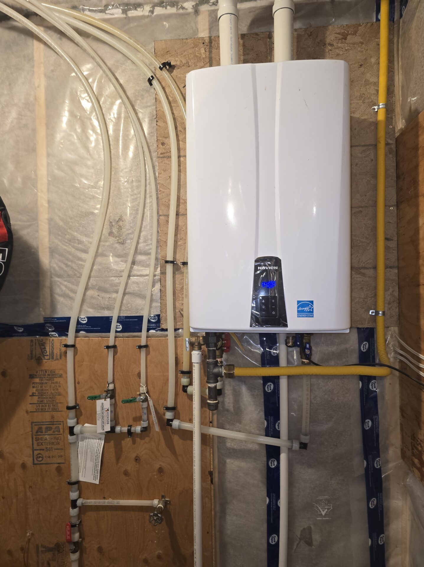 Navien tankless installed in finished basement with PVC venting — London Ontario