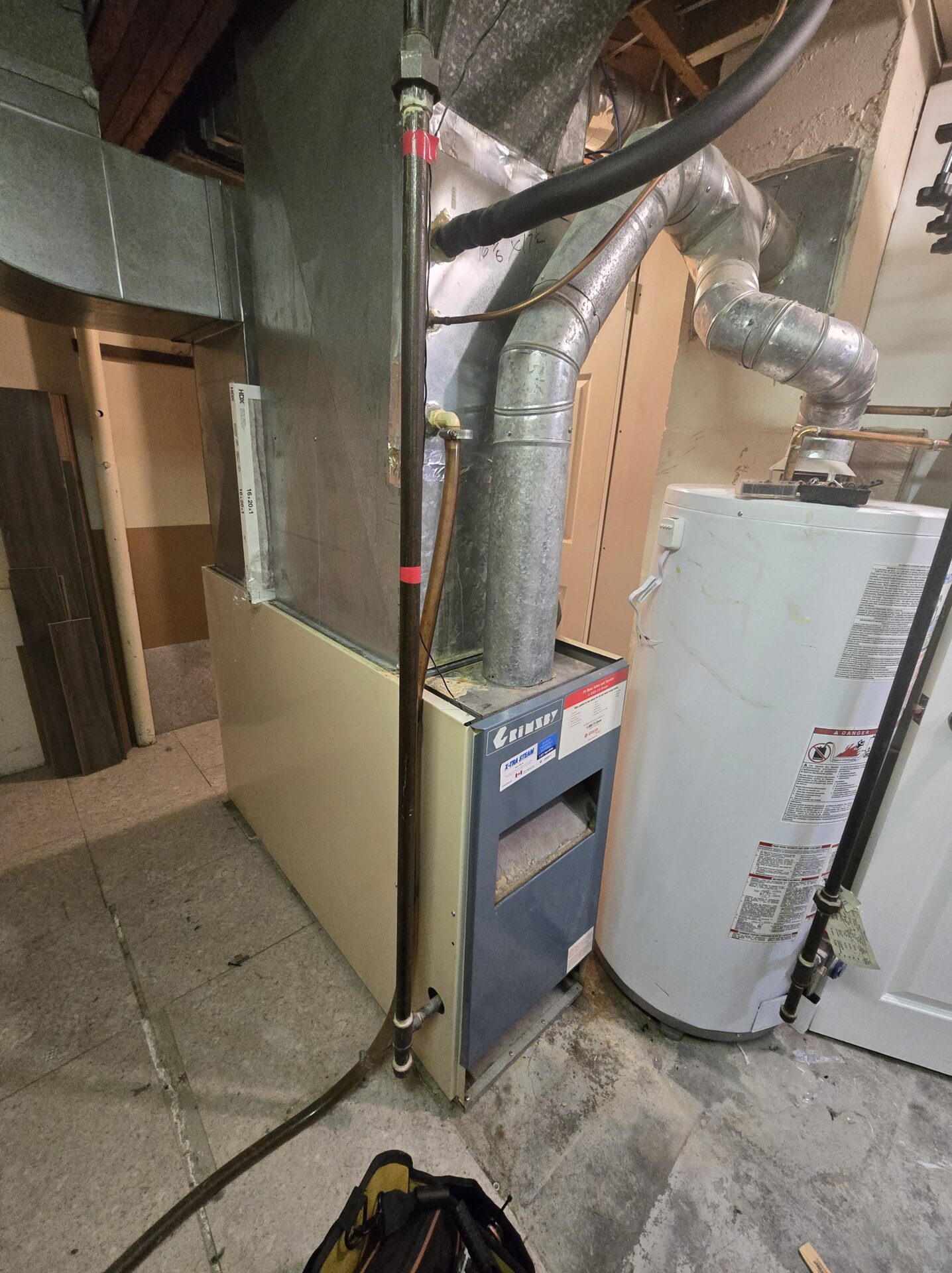 Aging low boy gas furnace in a London Ontario basement — replaced same-day by Hawana HVAC